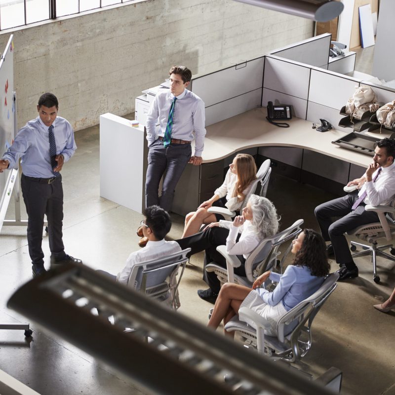 Businessman using whiteboard in a  meeting, elevated view